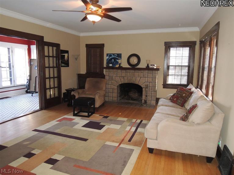 804 Raff Road Southwest Canton, OH 44710 - Photo 6 of 17 The beautiful living room features hardwood floors and wood burning stone fireplace and has french doors that open to the sun room.