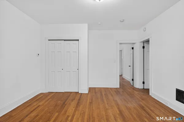a view of a room with wooden floor