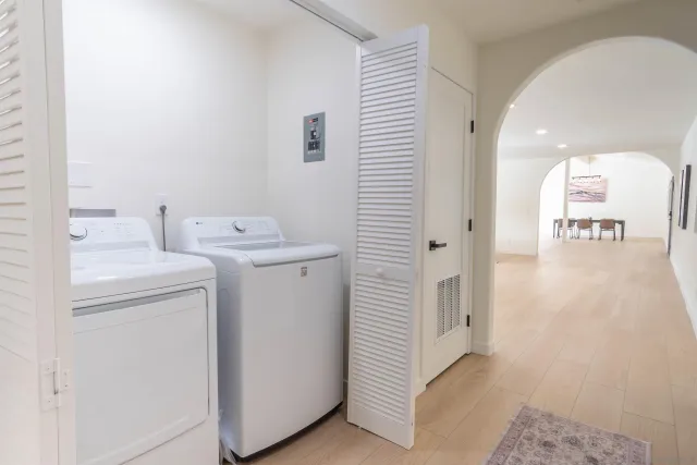 a view of a hallway with washer and dryer