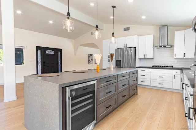 an open kitchen with granite countertop a stove and a sink