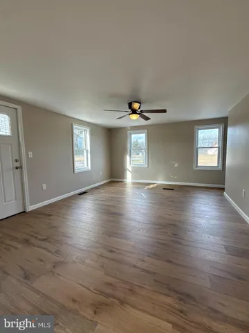 a view of livingroom and hall with wooden floor
