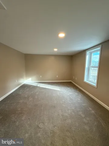 an empty room with a empty space and windows