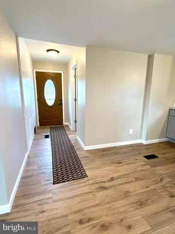 a view of a room with wooden floor