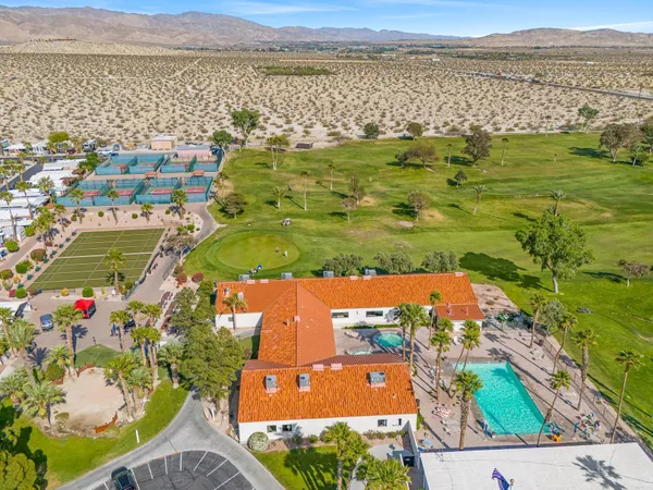 an aerial view of residential houses with outdoor space and ocean view