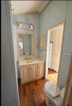 a bathroom with a granite countertop sink a mirror and a bathtub