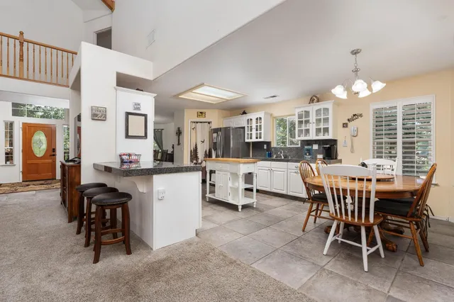 a large kitchen with a table and chairs