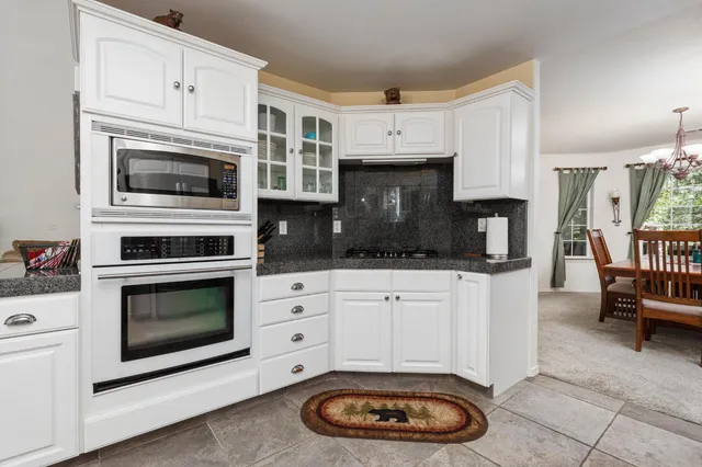 a kitchen with cabinets and appliances