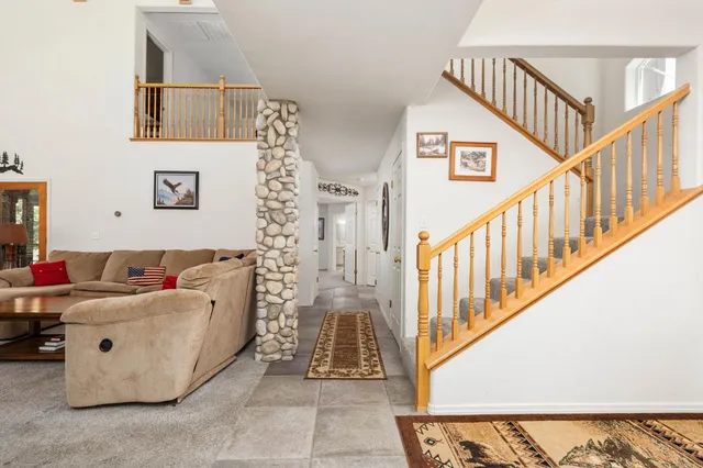a living room with furniture and a ceiling fan