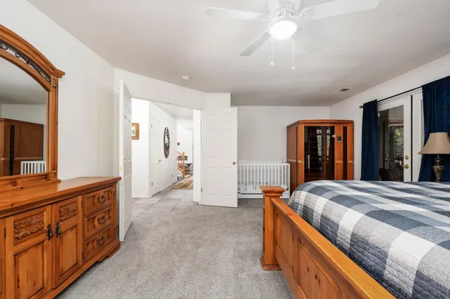 a spacious bedroom with a bed and a dresser