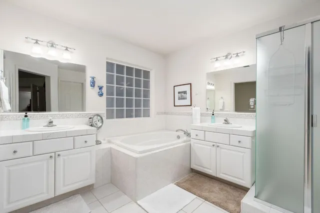 a bathroom with a sink a toilet a mirror a vanity and shower