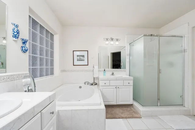 a bathroom with a sink mirror and shower