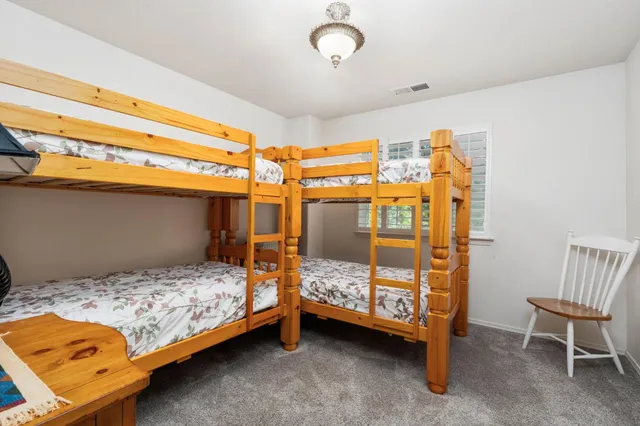 a bedroom with a bed and a chair