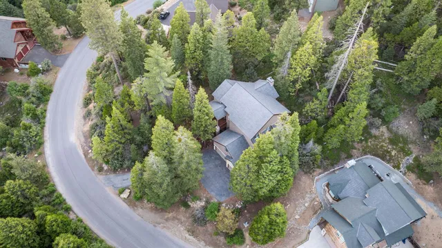 an aerial view of a house with garden space and sitting area