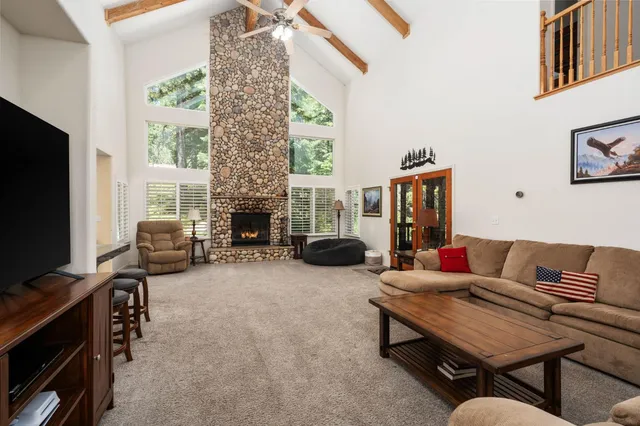 a living room with furniture a fireplace and a flat screen tv