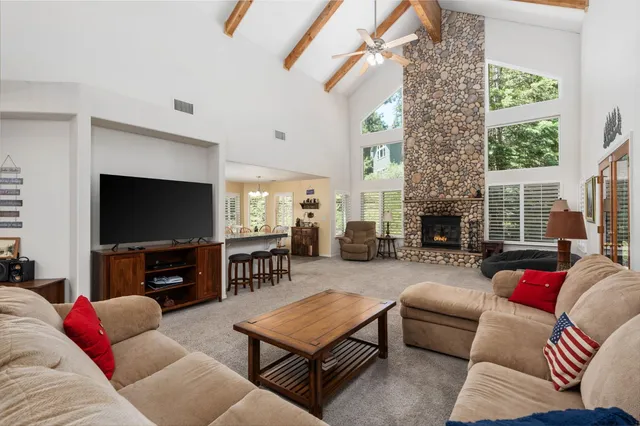 a living room with furniture flat screen tv and a fireplace