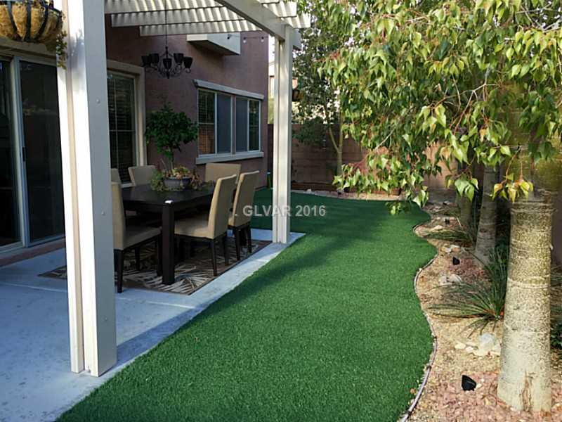 10554 Cave Ridge Street Las Vegas, NV 89179 - Photo 4 of 19 Exterior Back. Synthetic grass for low water usage