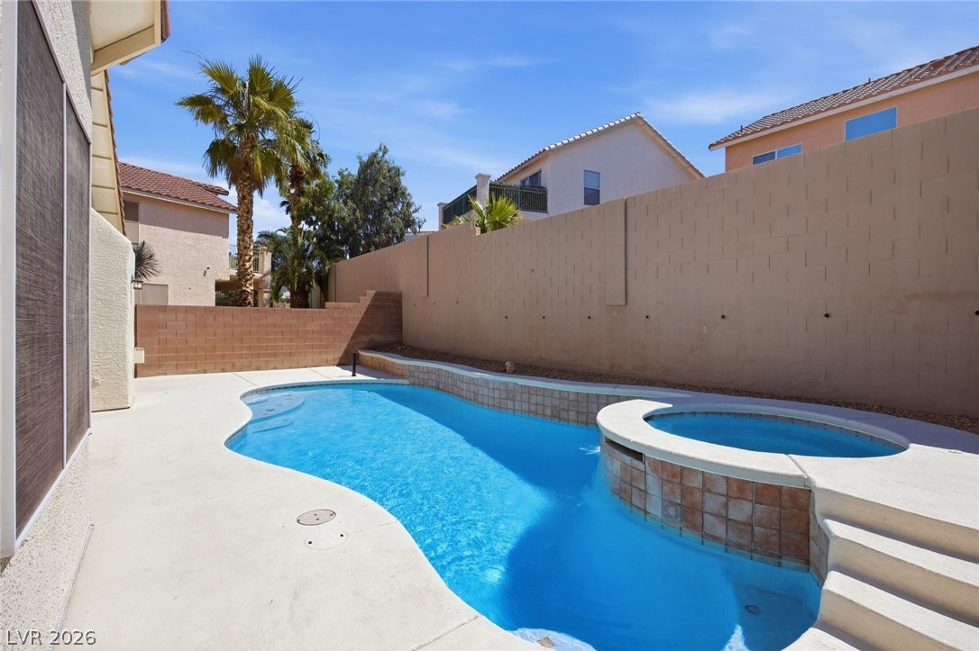 193 Oella Ridge Court Henderson, NV 89012 - Photo 29 of 32 A private oasis features a sparkling pool and spa, perfect for outdoor relaxation.