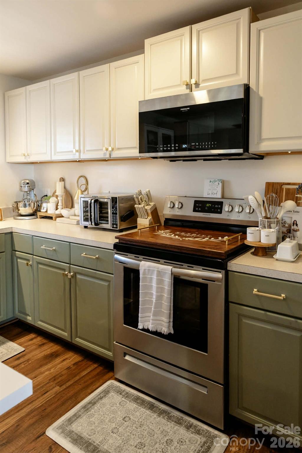 202 East Rice Street Landis, NC 28088 - Photo 13 of 23 a kitchen with stainless steel appliances a stove a microwave a sink and cabinets