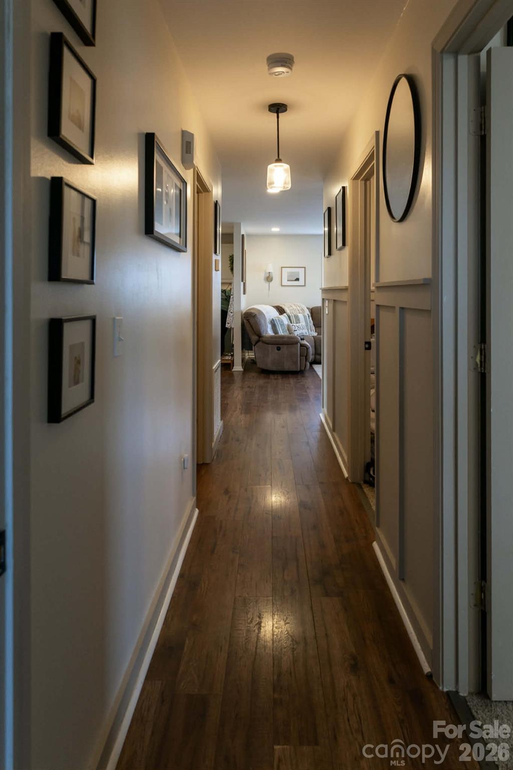 202 East Rice Street Landis, NC 28088 - Photo 14 of 23 a view of a hallway with wooden floor windows and a kitchen