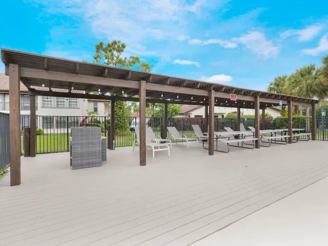 a view of a patio with a table and chairs and potted plants