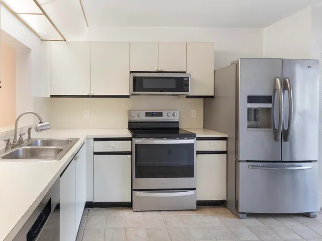 a kitchen with a sink and stainless steel appliances