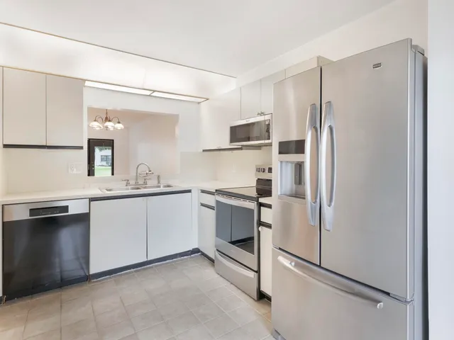 a kitchen with a refrigerator and a sink