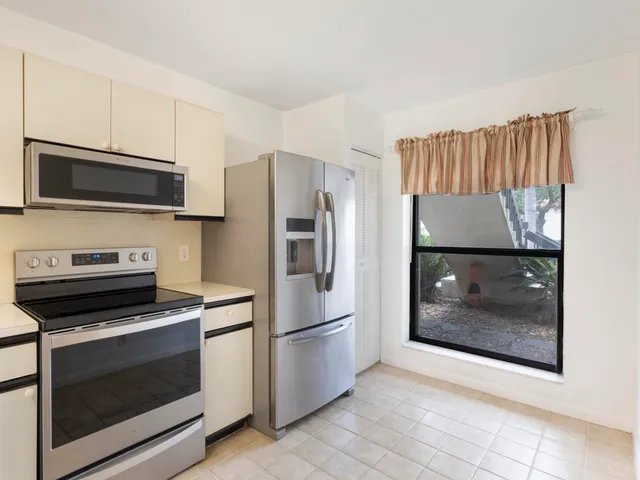 a kitchen with granite countertop a refrigerator and a stove