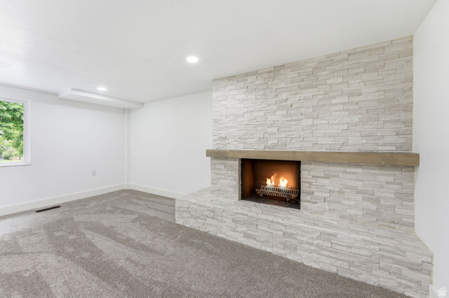 871 Bonita Way Centerville, UT 84014 - Photo 26 of 61 Stone-clad fireplace with a wood mantel