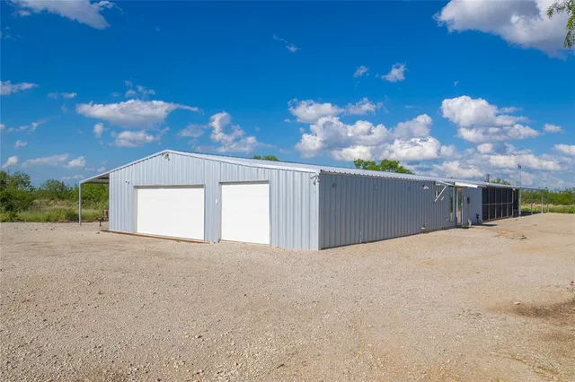 a view of a house with a yard and garage