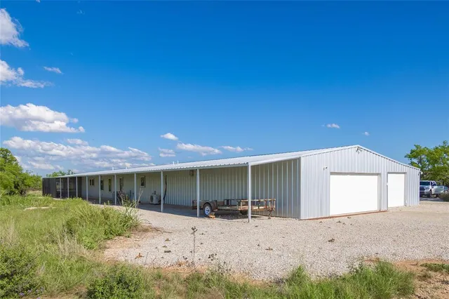 a view of a house with a yard and garage