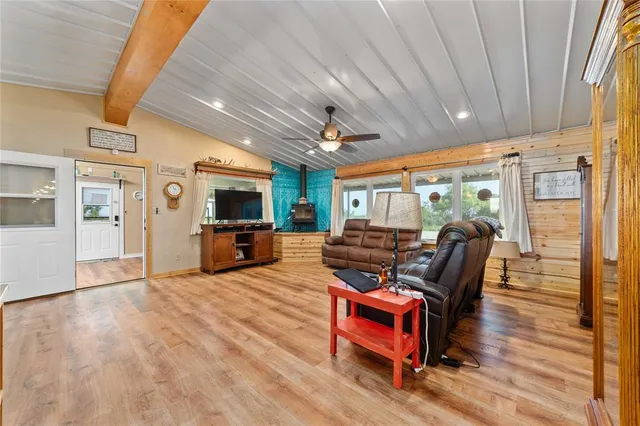 a living room with furniture a flat screen tv and wooden floor