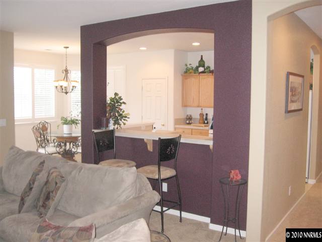 1310 Arbor Court Reno, NV 89521 - Photo 3 of 9 a large bedroom with a large bed and a potted plant