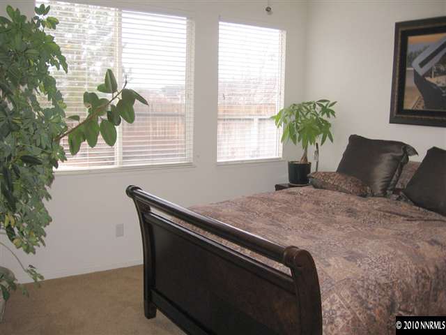 1310 Arbor Court Reno, NV 89521 - Photo 8 of 9 a bed sitting in a bedroom next to a window