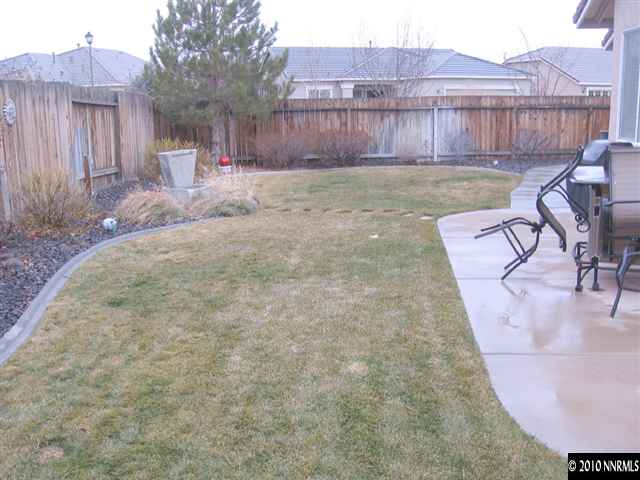 1310 Arbor Court Reno, NV 89521 - Photo 9 of 9 a view of a backyard with table and chairs with wooden fence