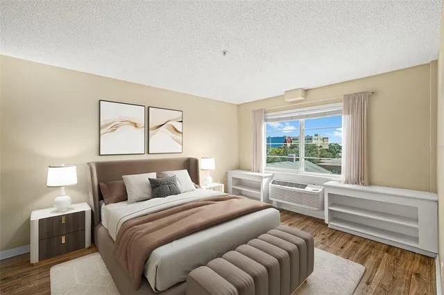 a bedroom with a bed and a large window