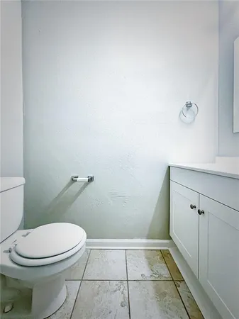 a white toilet sitting next to a shower