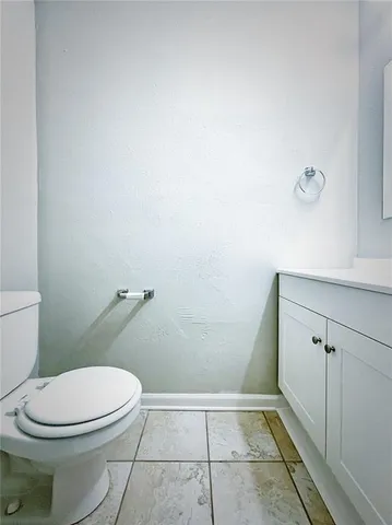 a white toilet sitting next to a shower