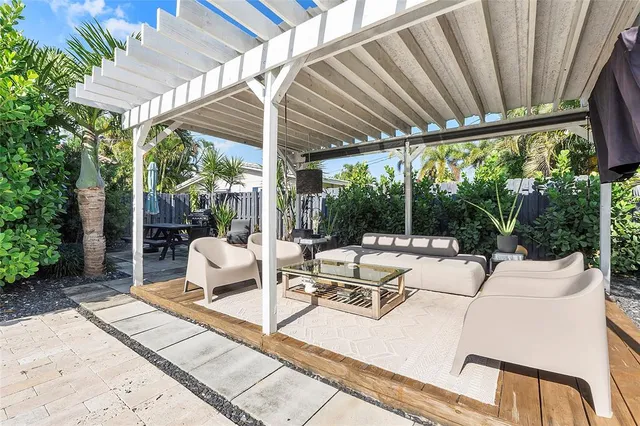 a view of a patio with a table chairs and backyard
