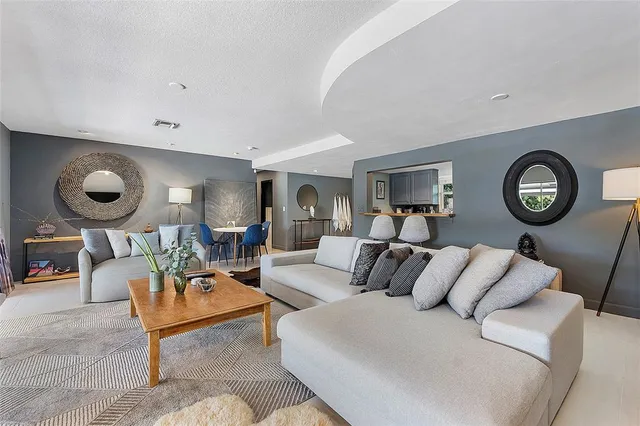 a living room with furniture and a clock