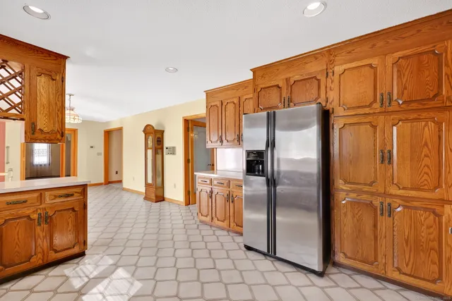 a kitchen with stainless steel appliances granite countertop a refrigerator a stove and a sink with granite countertops