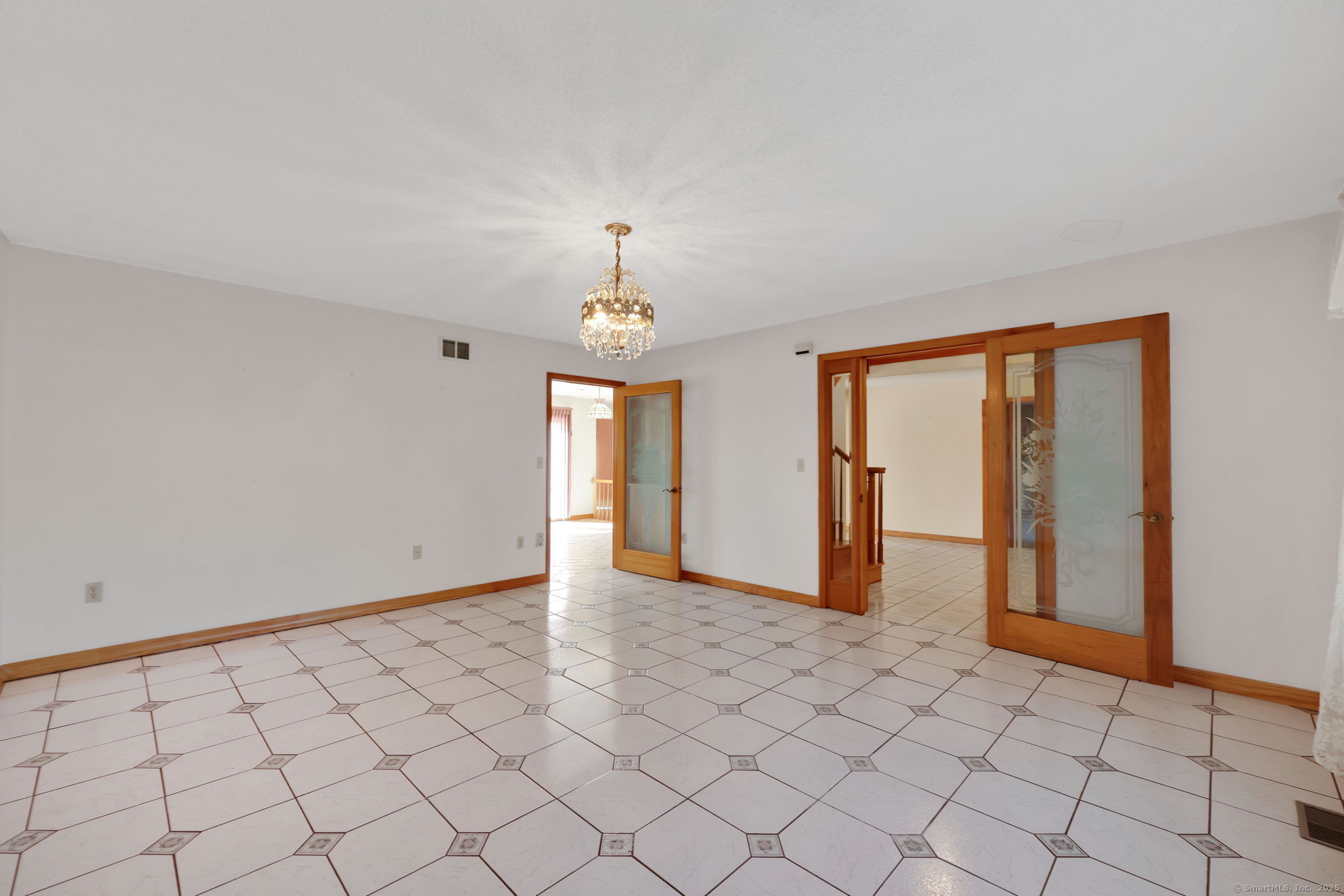 208 Highmeadow Lane Middletown, CT 06457 - Photo 16 of 34 an empty room with chandelier fan and windows