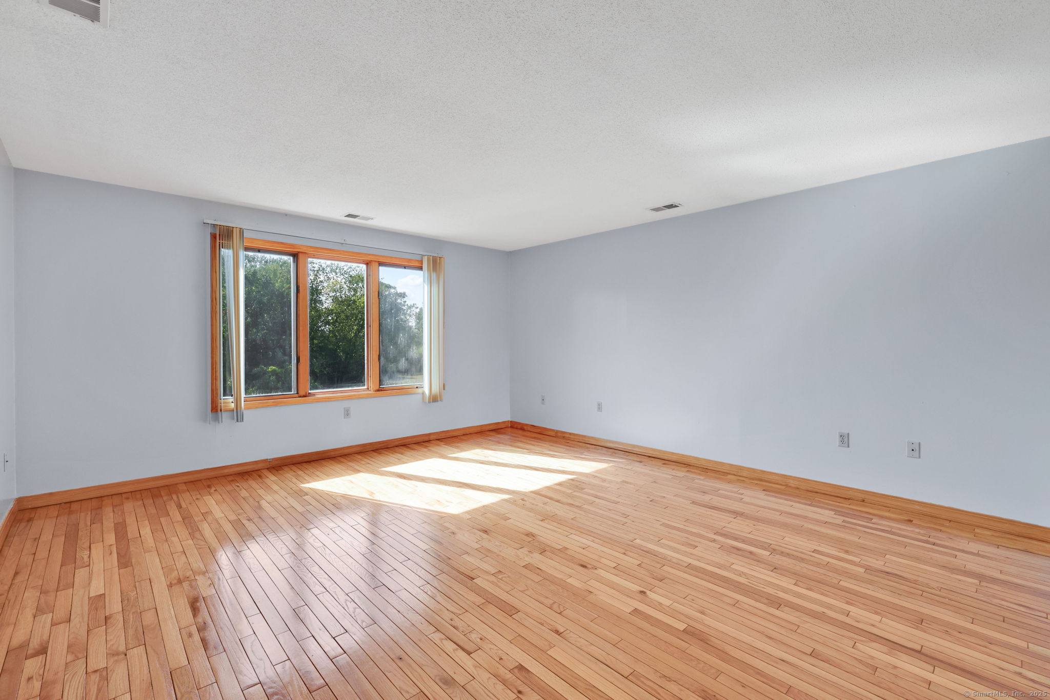 208 Highmeadow Lane Middletown, CT 06457 - Photo 30 of 34 a view of empty room with wooden floor and fan
