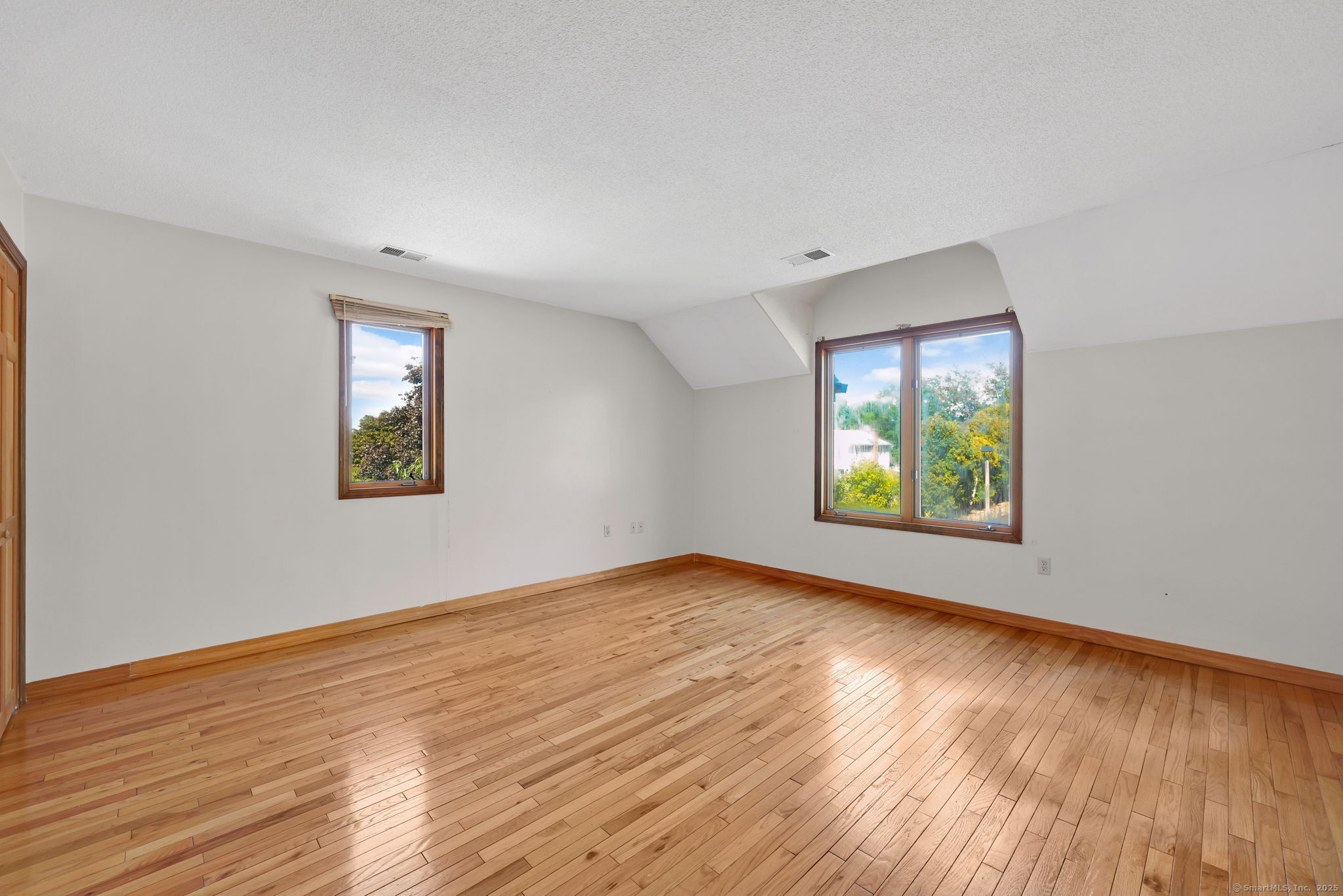 208 Highmeadow Lane Middletown, CT 06457 - Photo 33 of 34 an empty room with wooden floor and windows