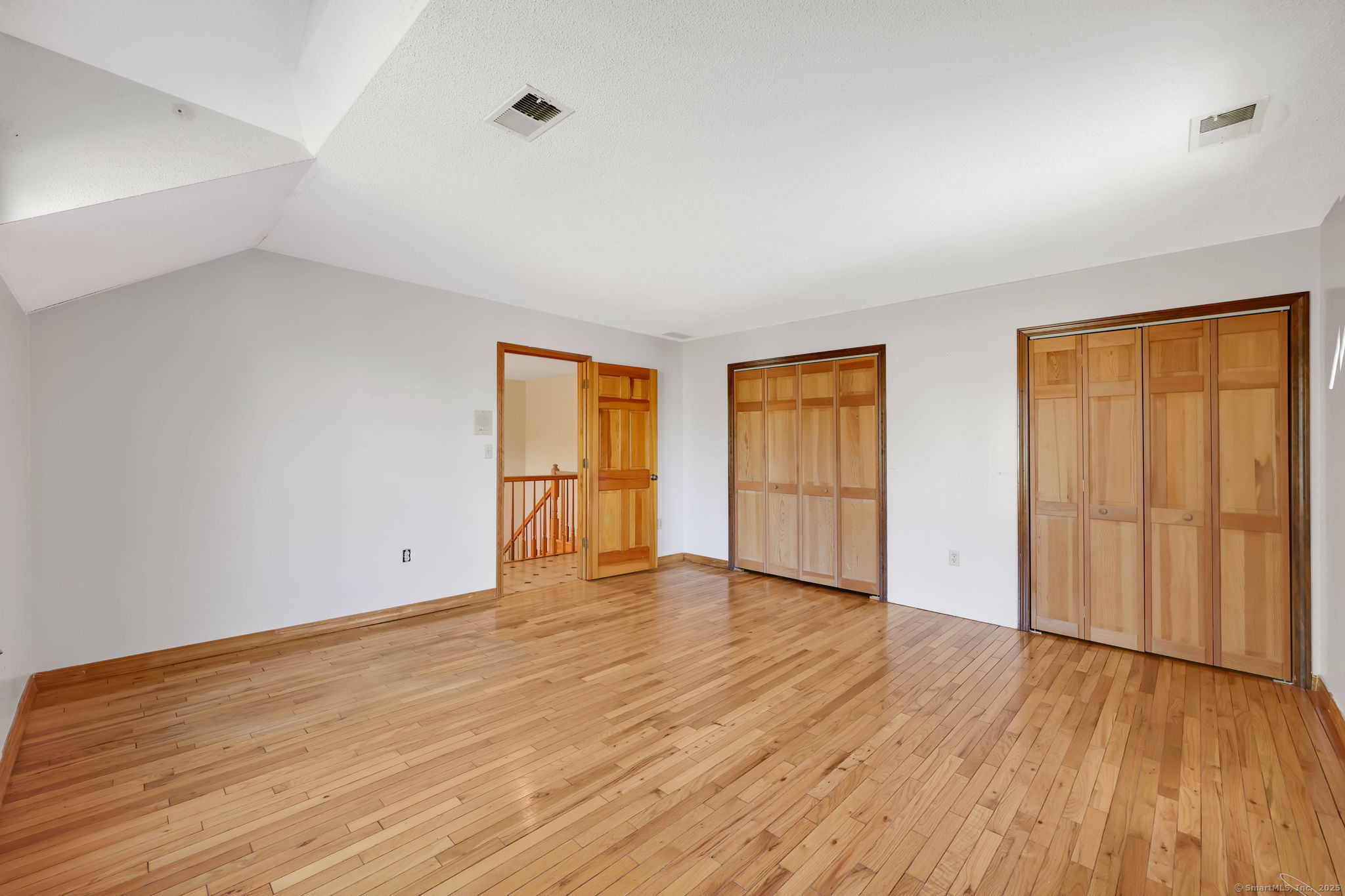 208 Highmeadow Lane Middletown, CT 06457 - Photo 34 of 34 an empty room with wooden floor and windows