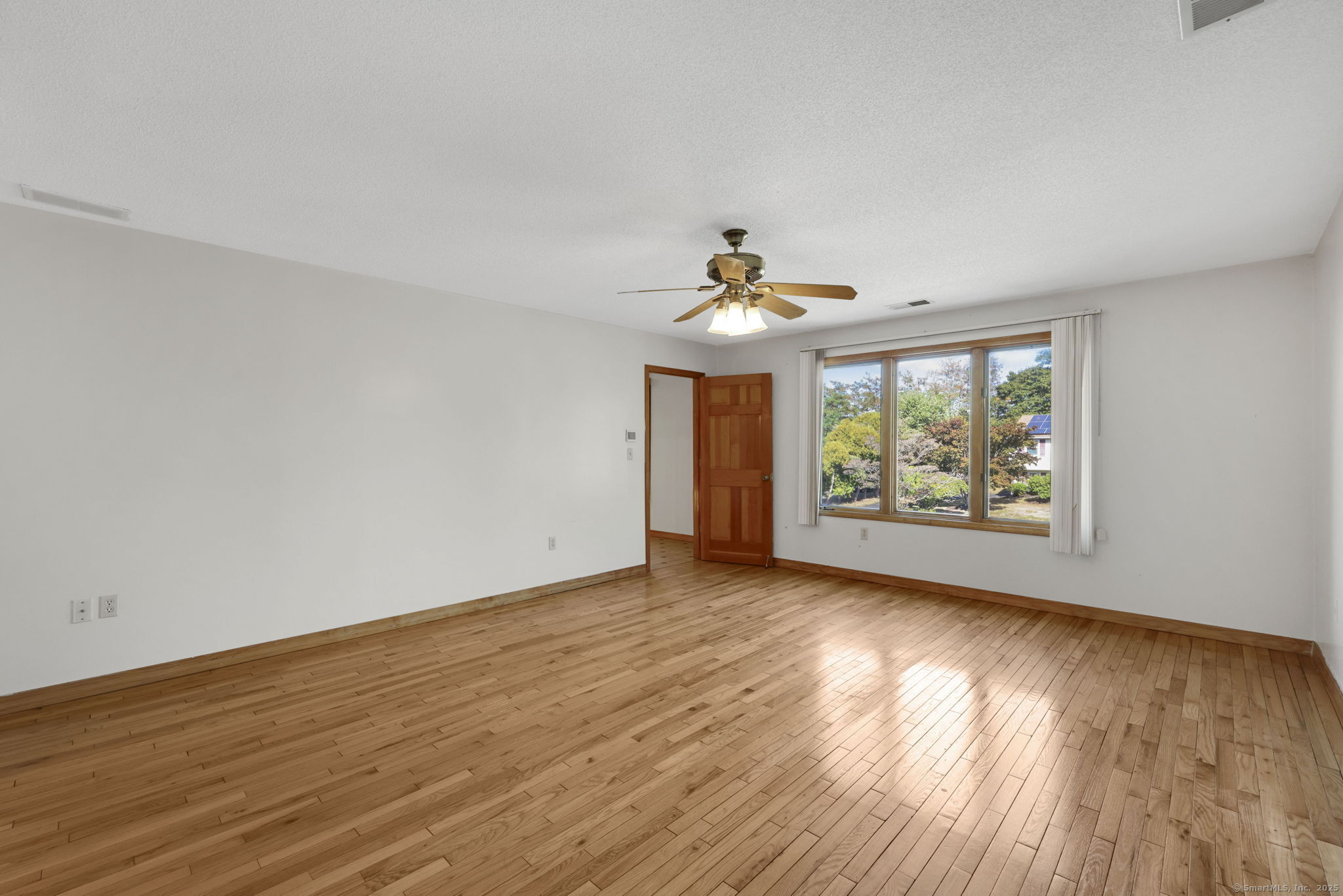 208 Highmeadow Lane Middletown, CT 06457 - Photo 5 of 34 a view of an empty room with wooden floor and a window