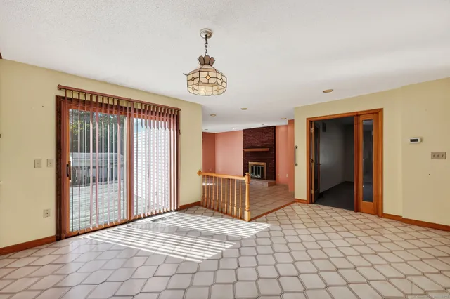 a view of a room with wooden floor