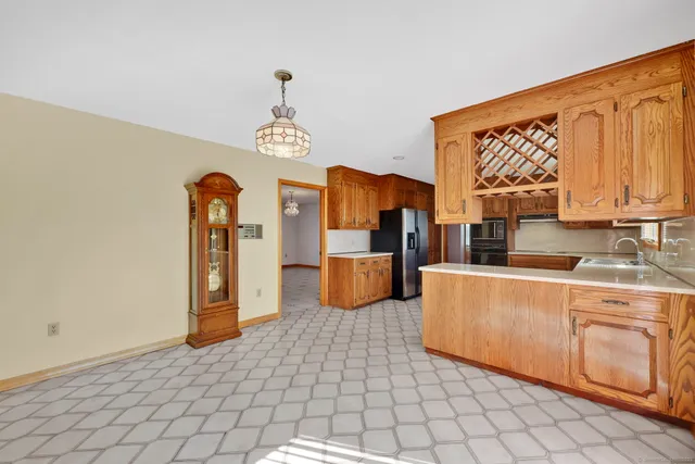 a kitchen with stainless steel appliances a stove a sink and a refrigerator with cabinets