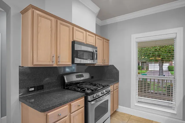 a kitchen with granite countertop a stove and a sink