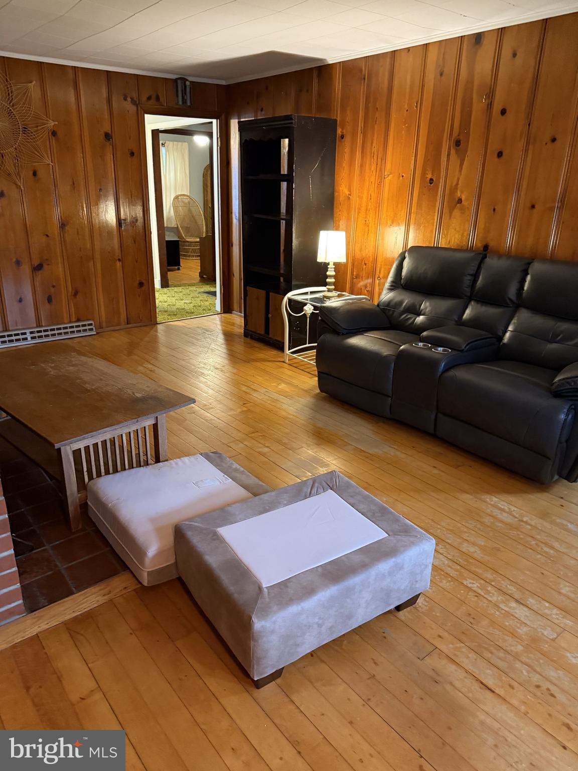 4870 Calvert Drive St. Leonard, MD 20685 - Photo 3 of 10 a living room with furniture rug and wooden floor