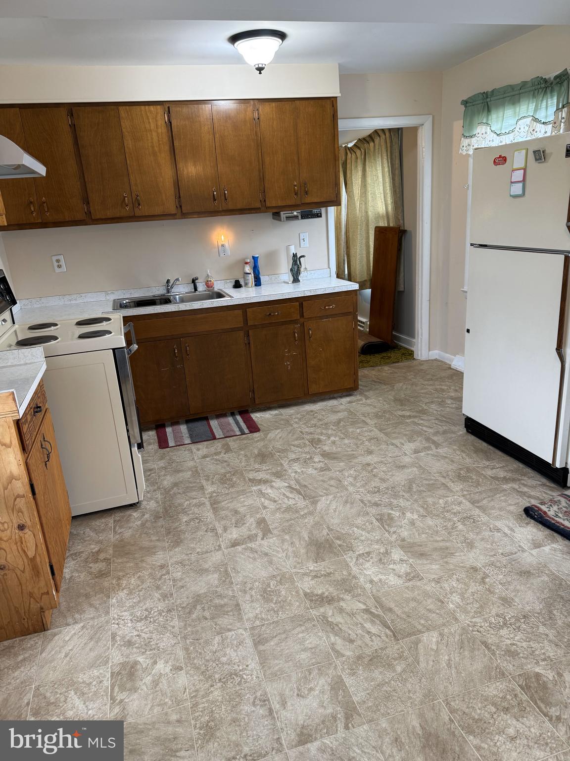 4870 Calvert Drive St. Leonard, MD 20685 - Photo 4 of 10 a kitchen with a refrigerator sink and cabinets